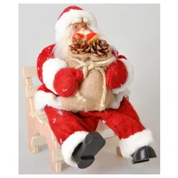Crveni deda Mraz na stolici 30 cm Crveni deda Mraz na stolici 30 cm